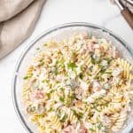 Creamy pasta salad in a large glass bowl.