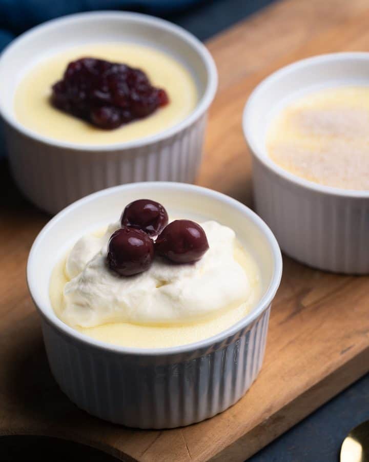 Three ramekins with creamy semolina pudding and different toppings.