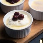 Three ramekins with creamy semolina pudding and different toppings.