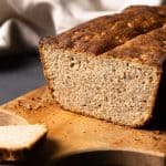 A seeded rye bread on a wooden board.