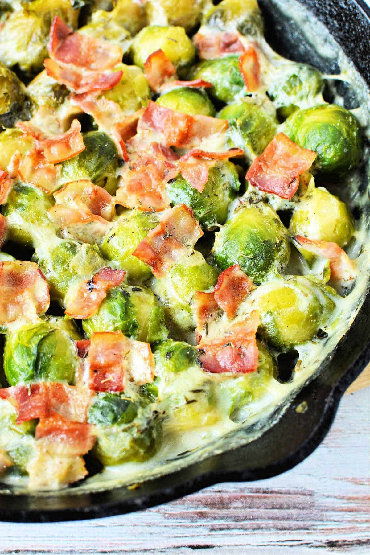 Brussel sprouts cooked in a cast iron skillet served as a side.
