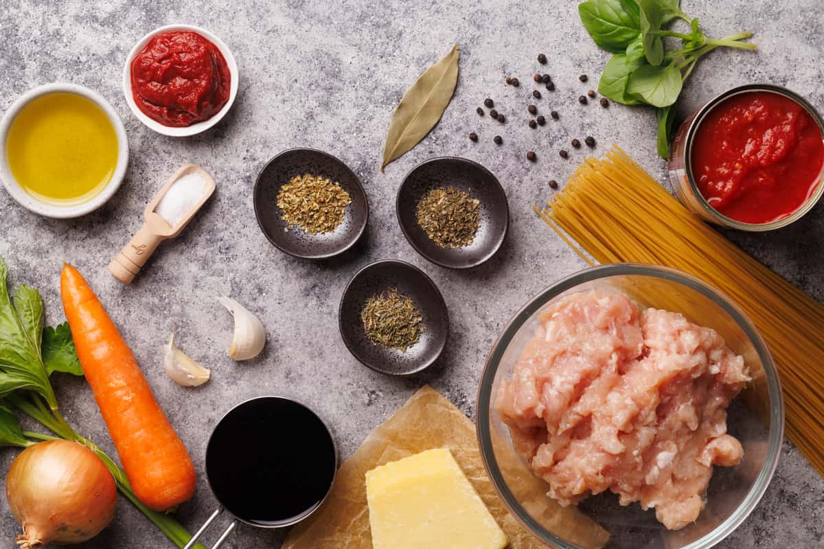 Ingredients laid out for chicken spaghetti bolognese.