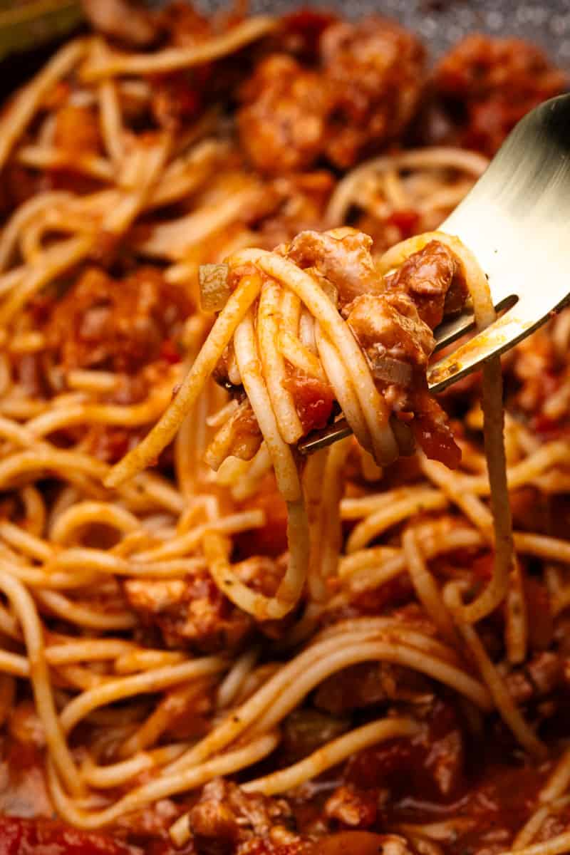 Close-up of a fork with ground Chicken Spaghetti Bolognese.