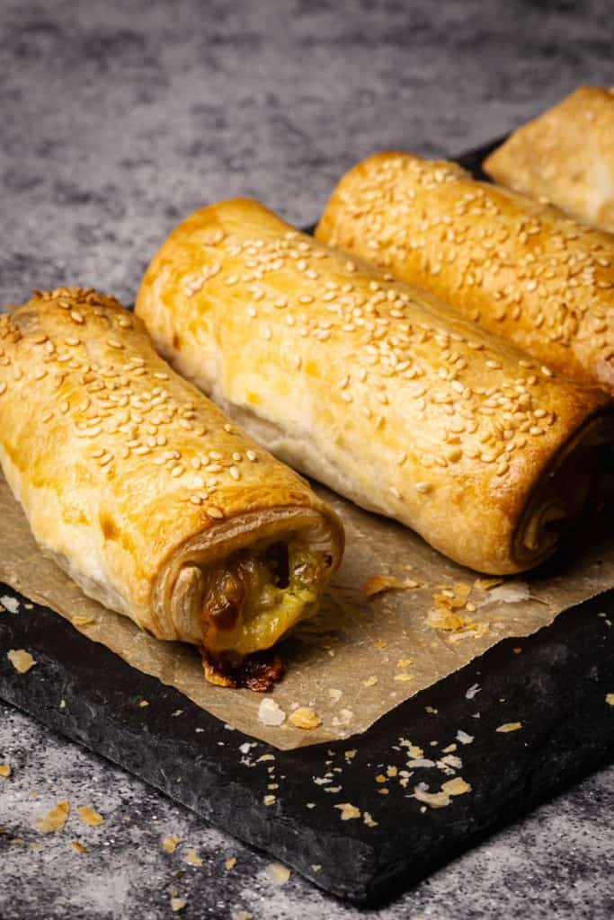 Puff pastry hot dogs on baking paper.