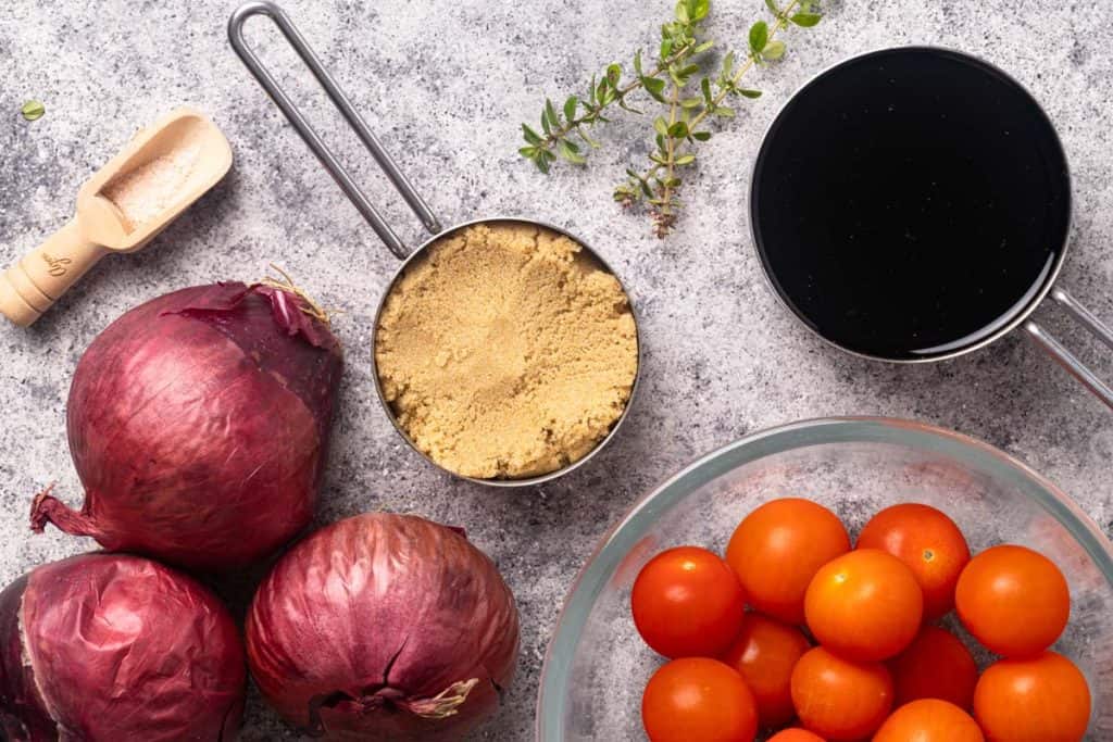 Ingredients to make caramelized onion tomato jam.