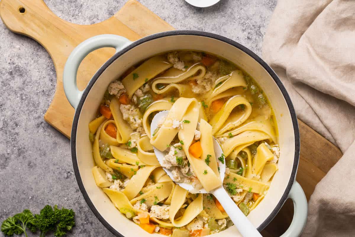 Chicken soup with noodles in a large Dutch oven.