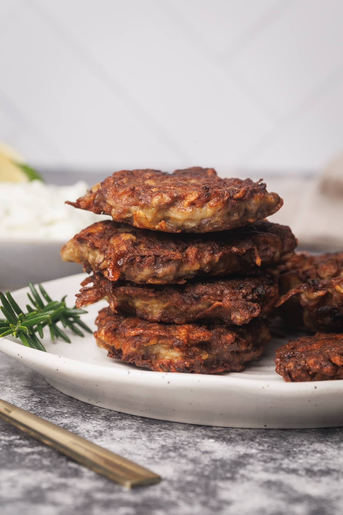 A stack of beef fritters on a white plate.