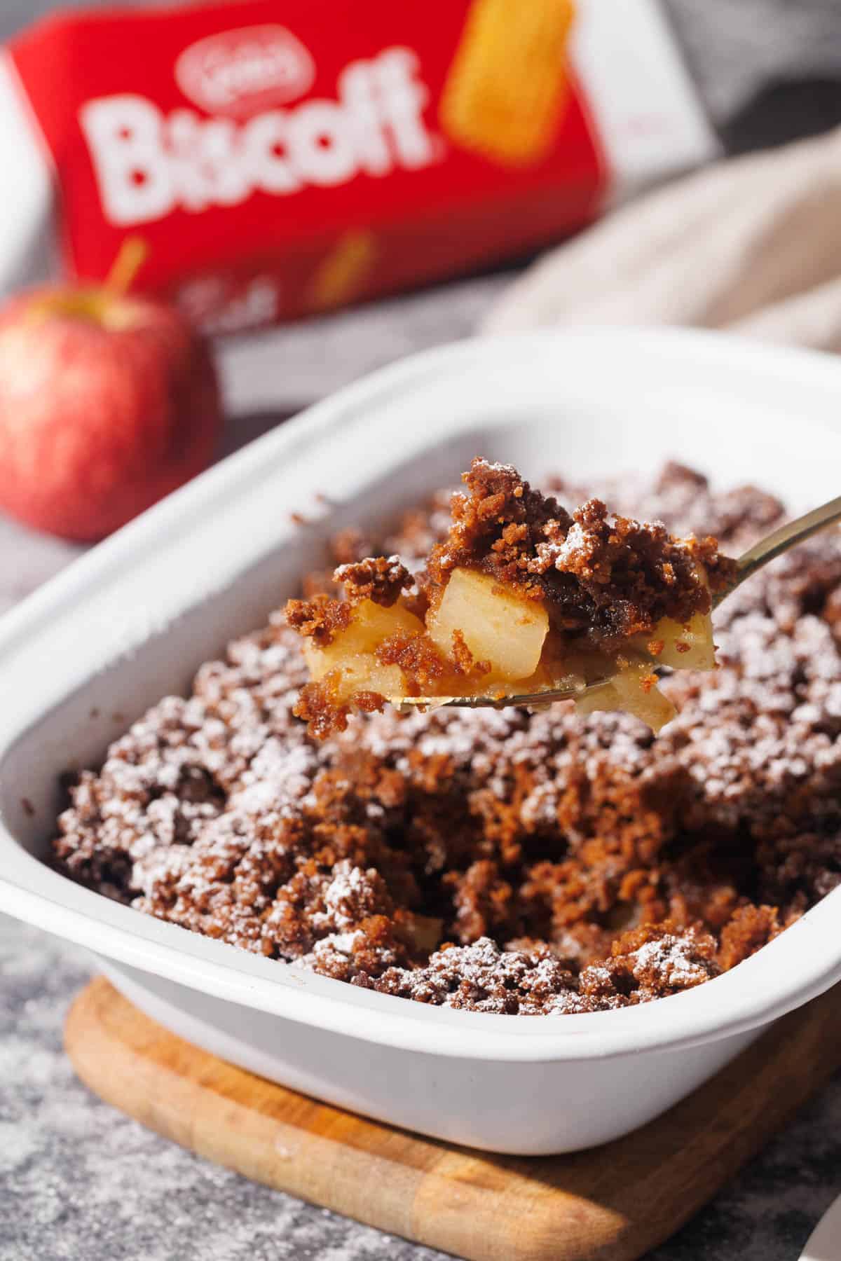 Apple crisp being scooped out of the baking dish.