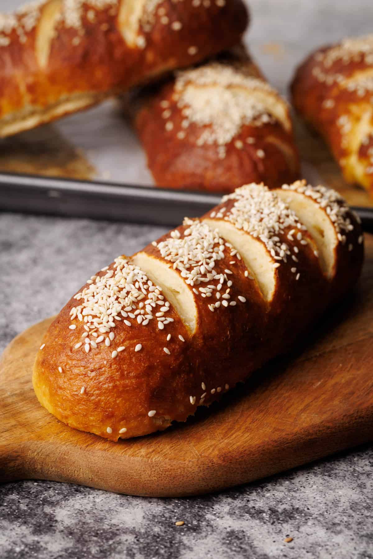 A pretzel bun on a wooden board.