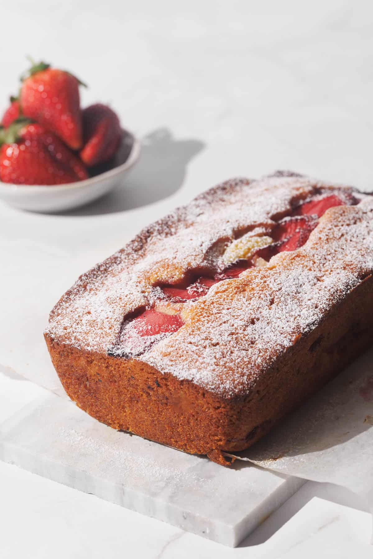 Strawberry cake on a marble tray.