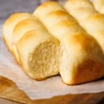 Hawaiian dinner rolls on a board.