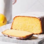 Lemon pound cake sliced on a marble slate.