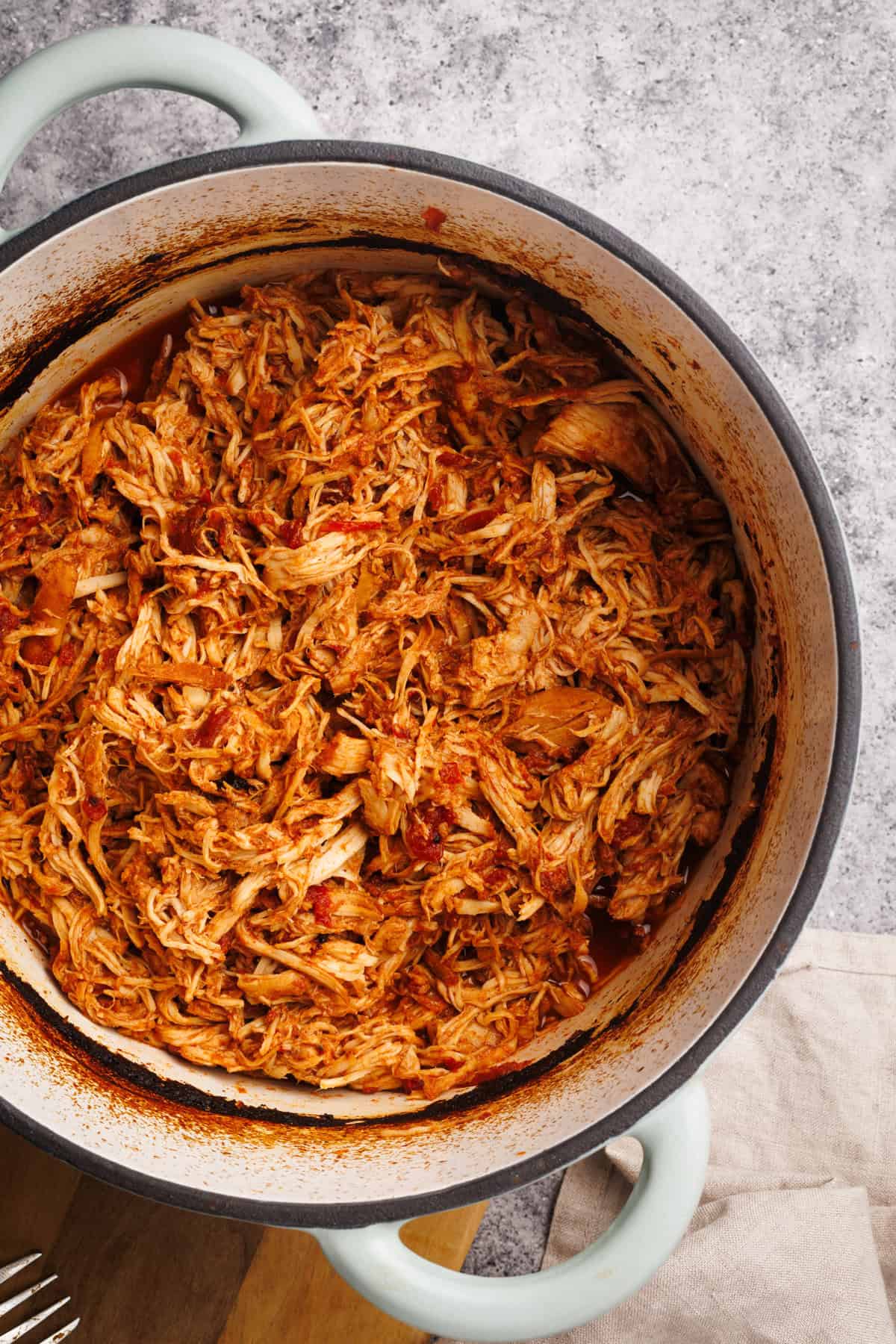 Pulled chicken in a Dutch oven.