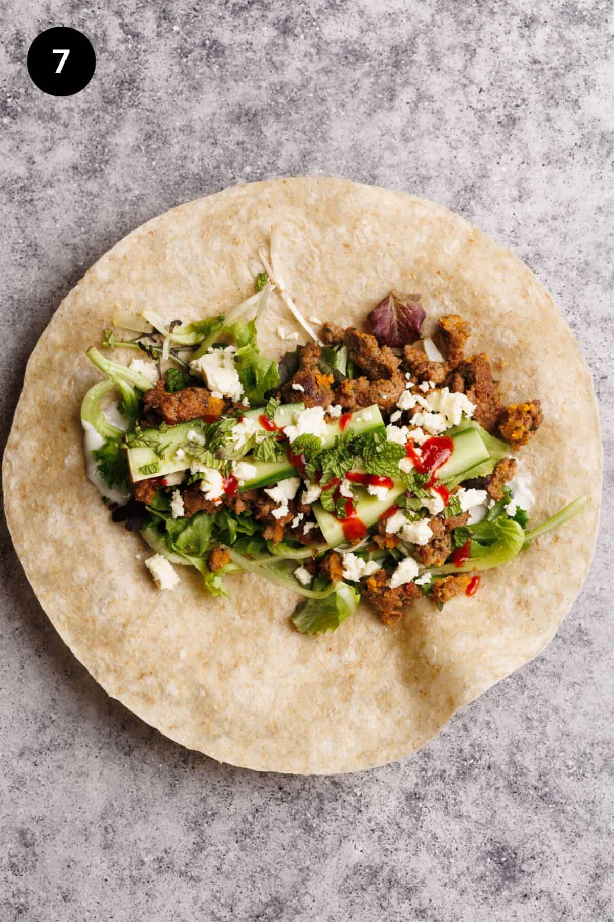 Lamb wrap fillings on a tortilla.