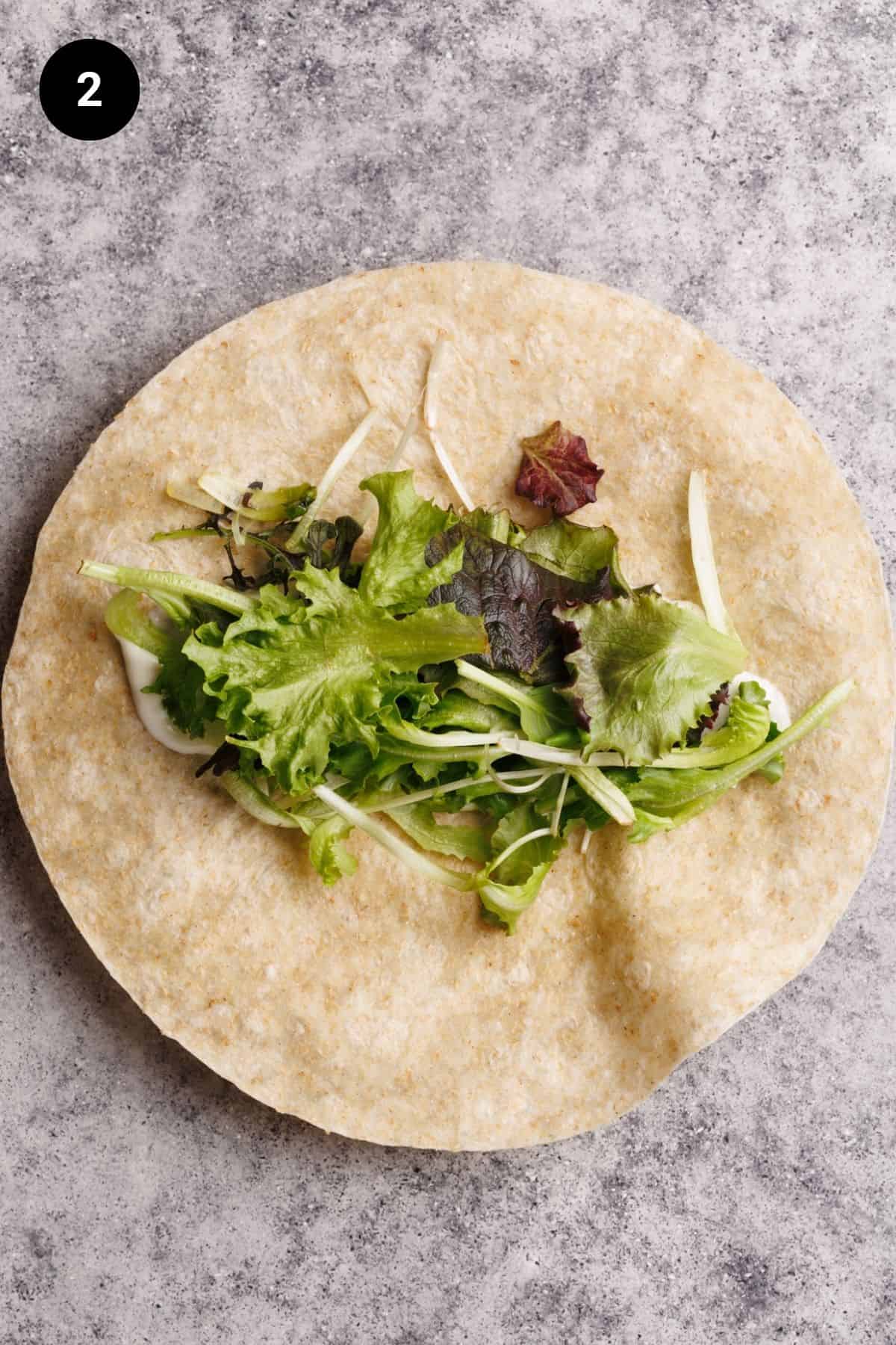 Salad on a flour tortilla.