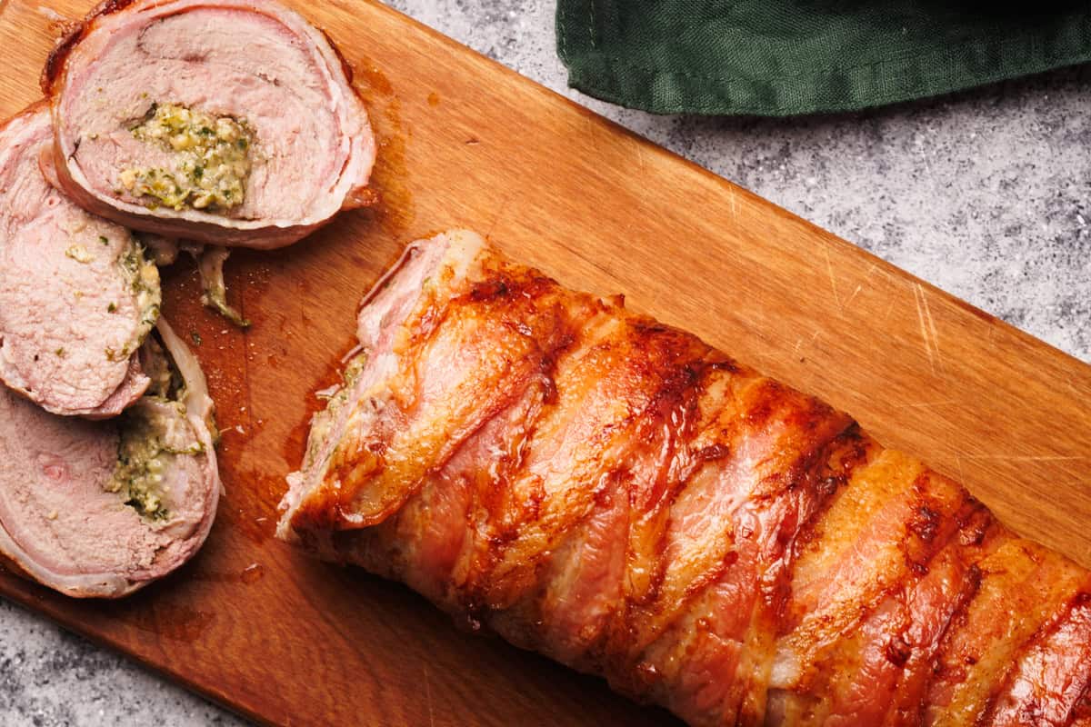 Stuffed lamb leg on a wooden board.