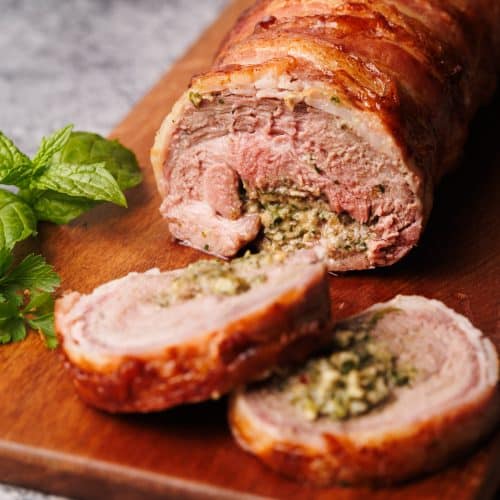 Stuffed lamb leg on a wooden board.