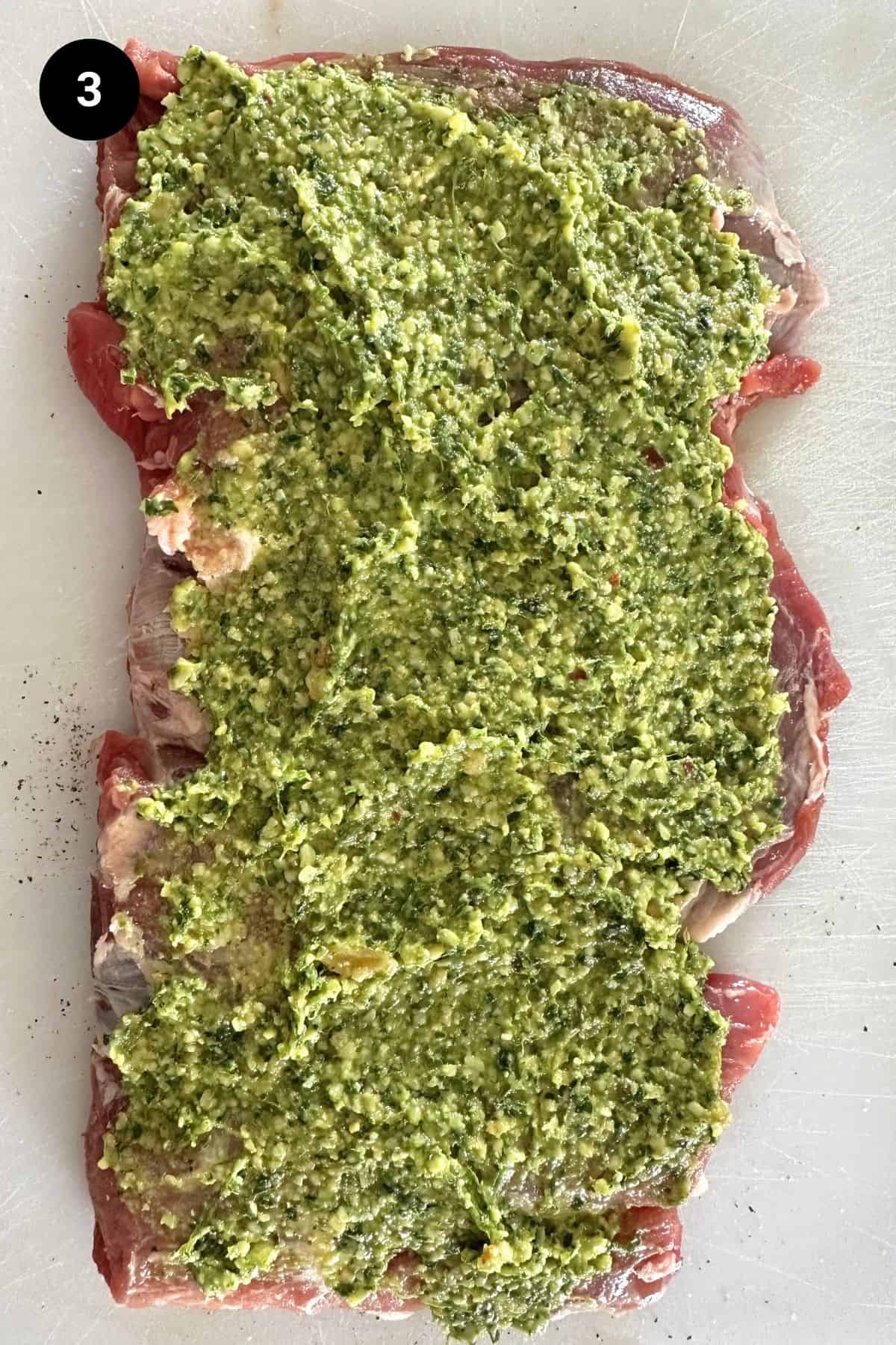 Pesto covered butterflied lamb leg.