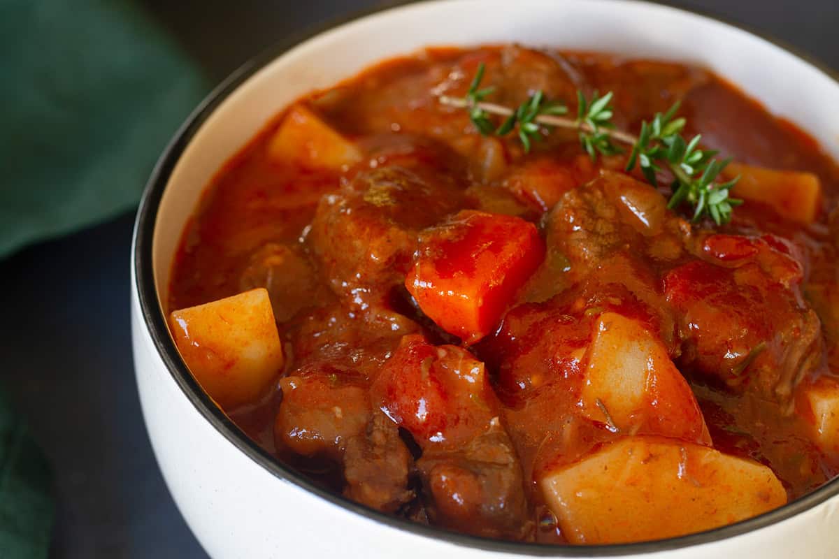 Beef stew in a small white bowl.