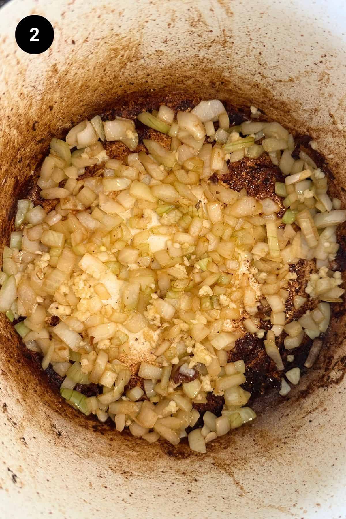 Sautéing onion and garlic in a Dutch oven.