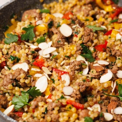 Lamb couscous in a grey pan.