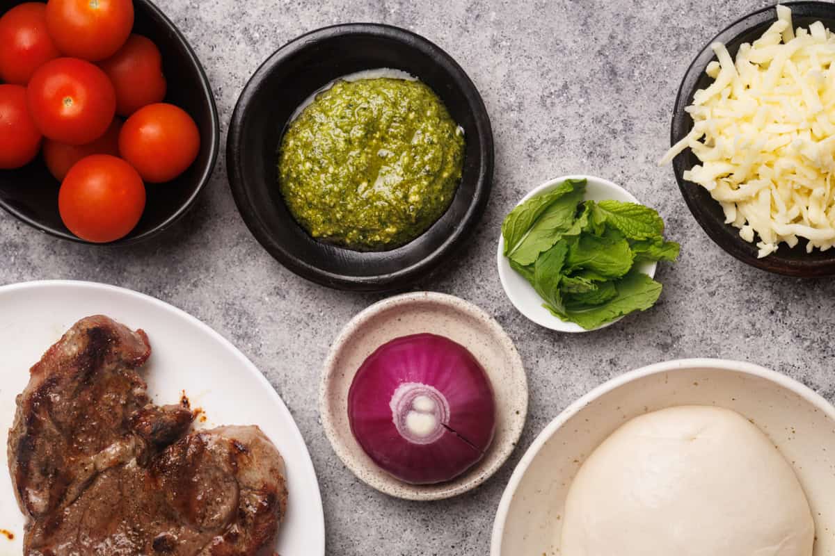 Ingredients used to make steak pesto pizza.