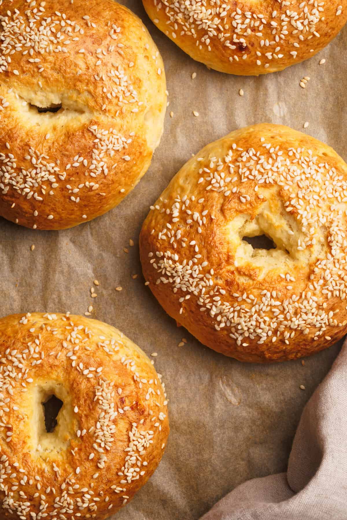 Cottage cheese bagels on a lined baking sheet.