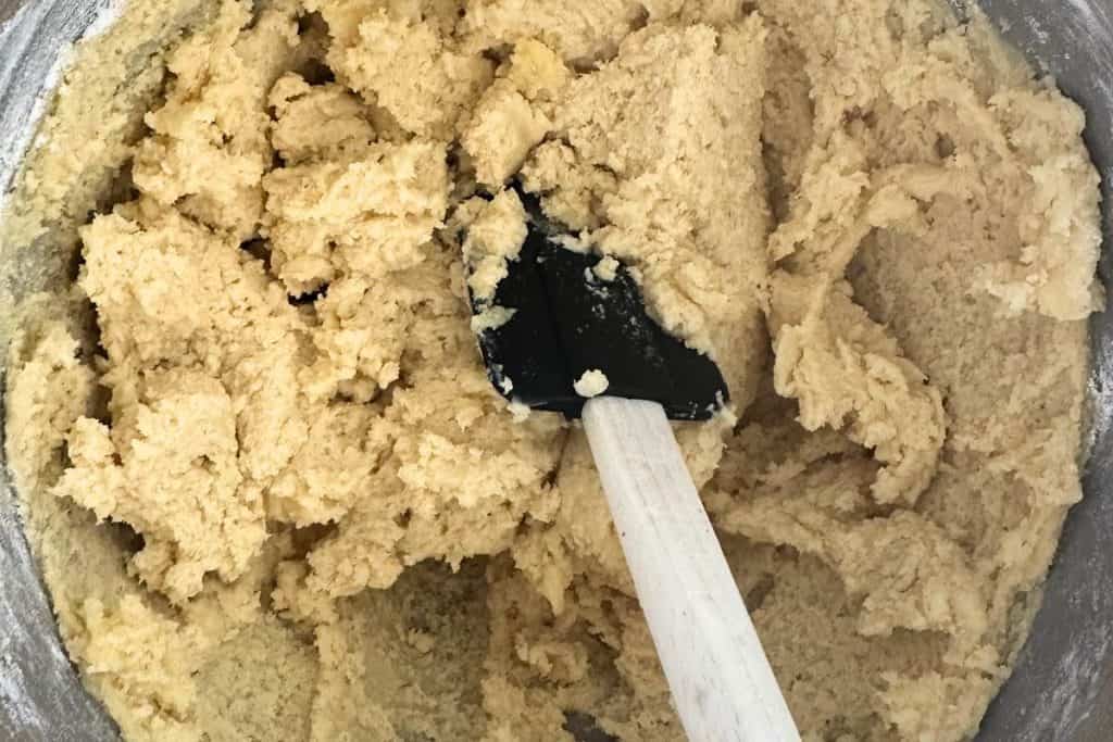 Soft spritz cookie dough in a metal bowl.