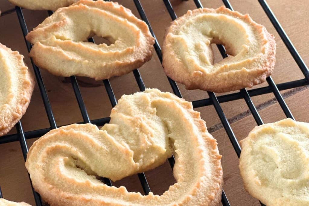 A cooling rack with spritz cookies.