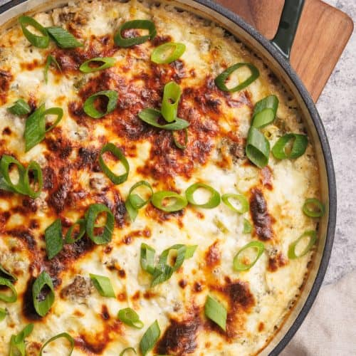 Casserole dish on a wooden board, top down view.