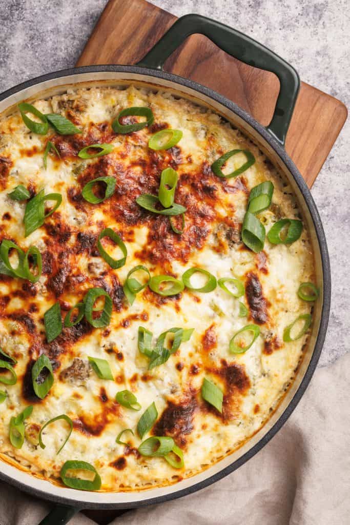 Casserole dish on a wooden board, top down view.