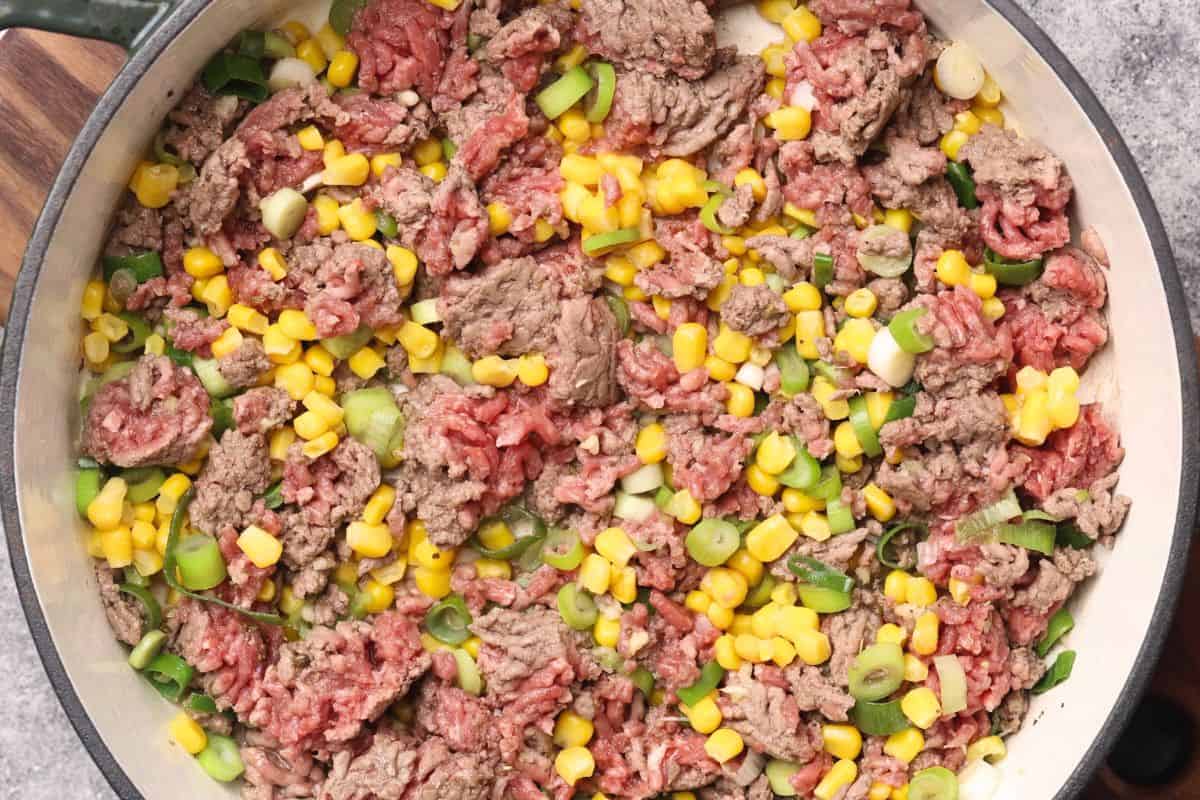 Ground beef skillet with corn and chopped green onions.