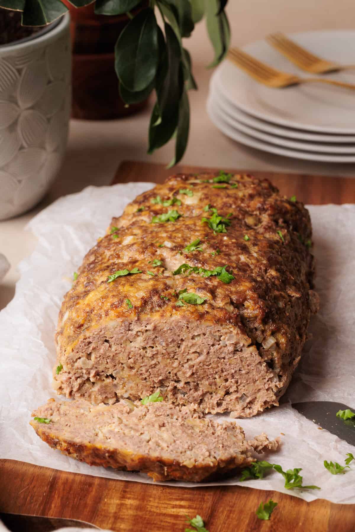 Cottage Cheese Meatloaf on a wooden board, sliced.