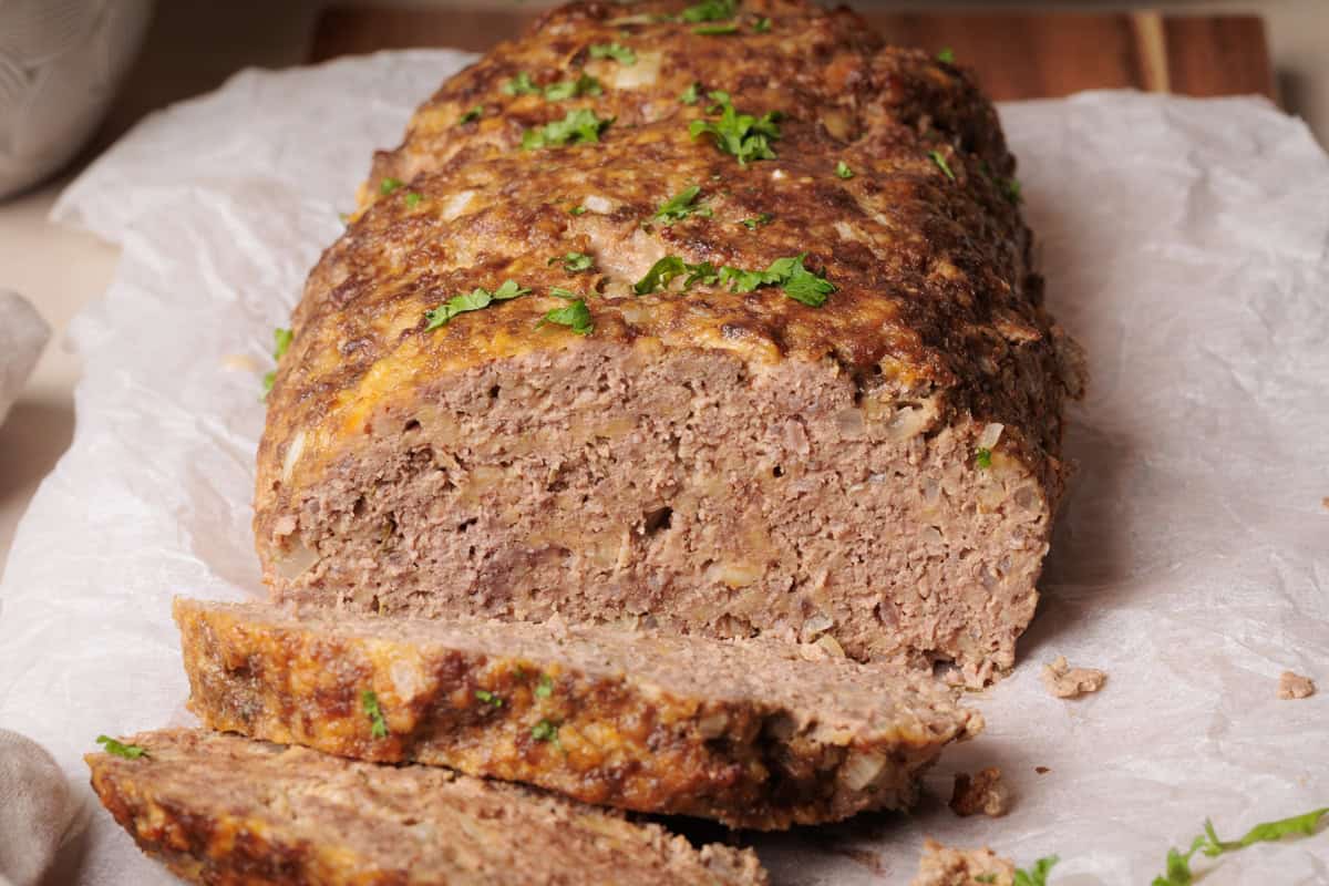 Cottage Cheese Meatloaf on a wooden board, sliced.