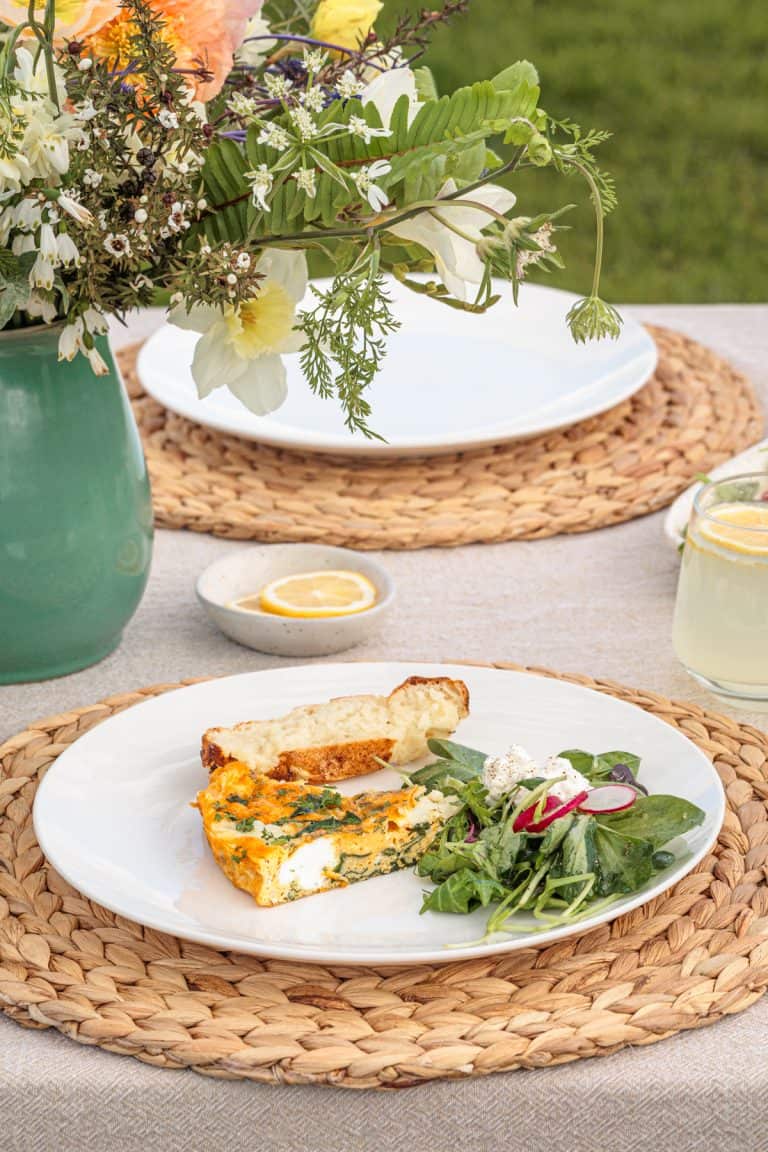 Garden Frittata with Cottage Cheese on a white plate next to bread and salad.