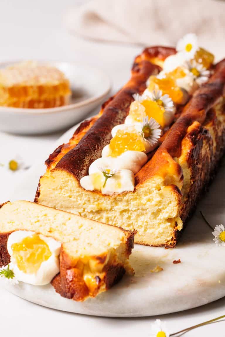Honey Basque cheesecake on a marble board.