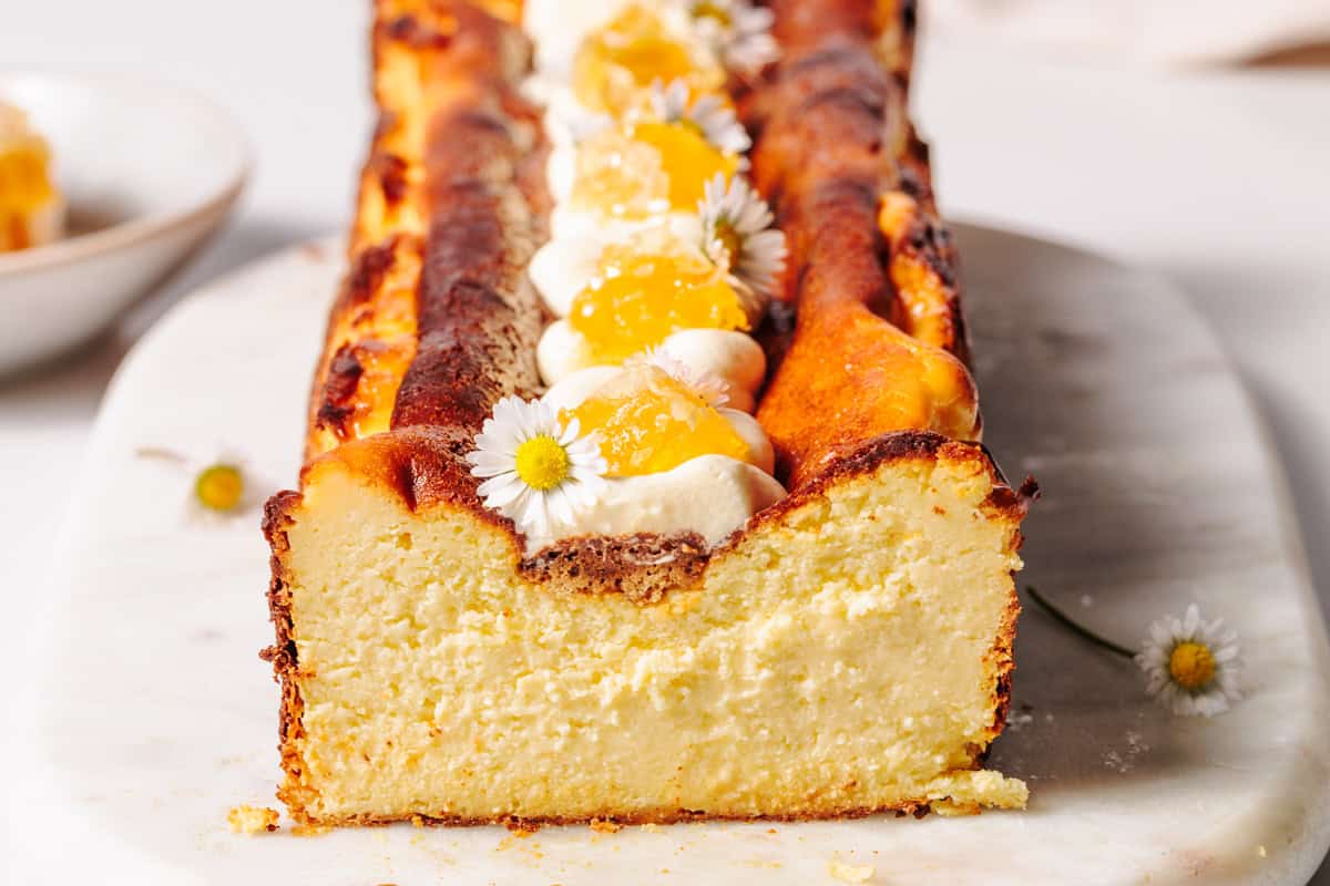 Honey Basque cheesecake on a marble board.