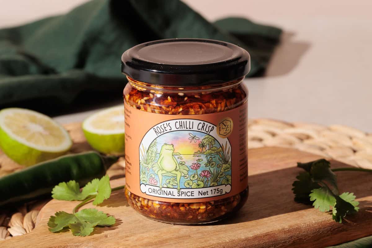 Crispy chili oil on a wooden board next to a tin.