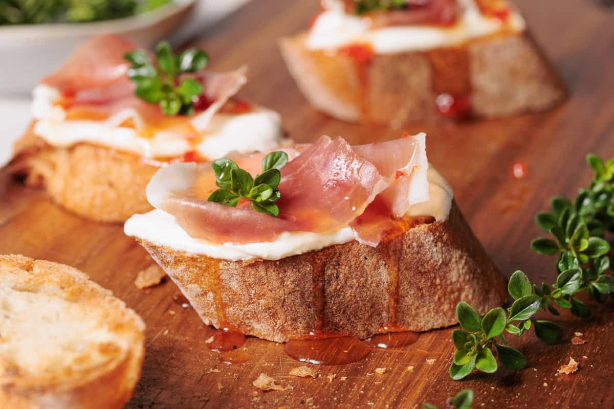 Cottage cheese crostini on wooden  board.